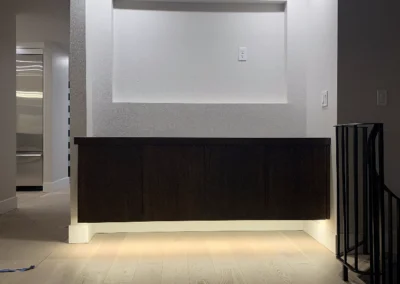 Entertainment wall with LED accent lighting under a cabinet