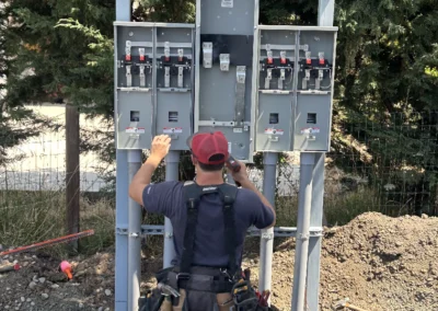 Electrician installing a multi-meter pedestal with conduit
