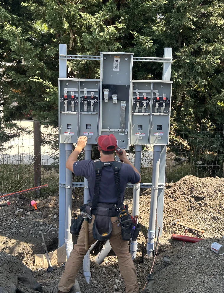 Electrician installing a multi-meter pedestal with conduit