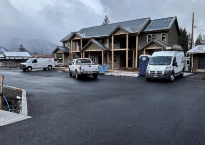 New townhome construction site with work vans in the lot