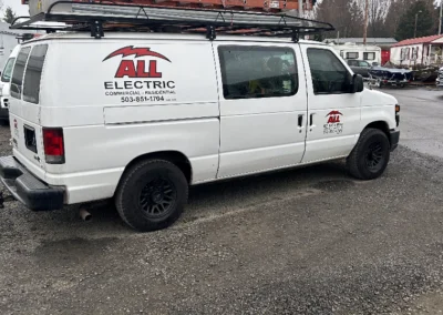 White All Electric work van parked on gravel